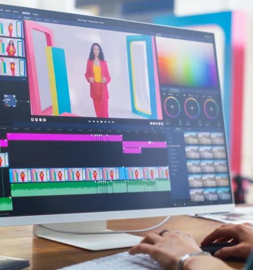 A designer at a computer screen assembling various brand elements.