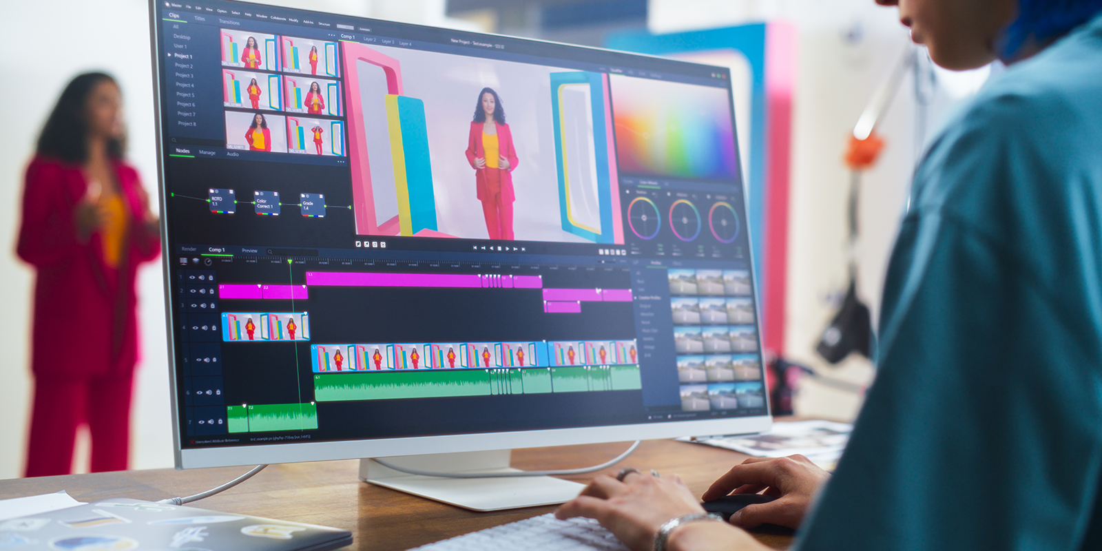 A designer at a computer screen assembling various brand elements.